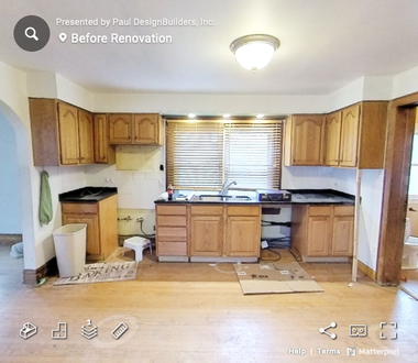 A before renovation photo of a kitchen with wooden cabinets