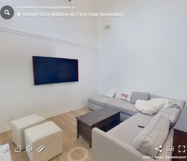 A living room with a couch and a flat screen tv