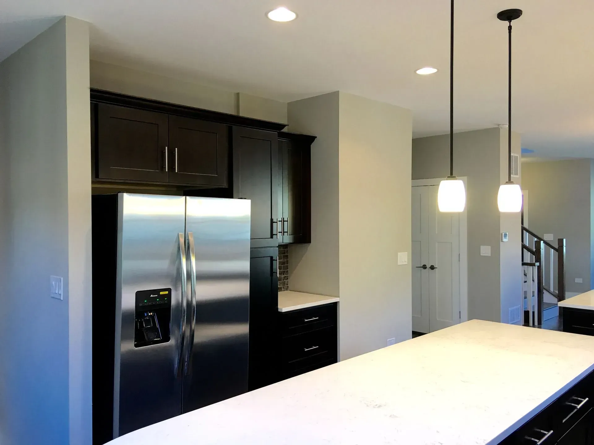 A kitchen with stainless steel appliances and black cabinets
