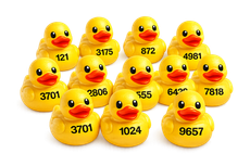 Yellow rubber ducks with black numbers printed on them, arranged in a pyramid on a white background