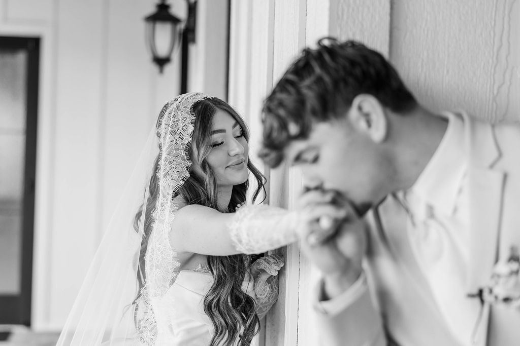 Bride and groom near a doorway in a black-and-white wedding photo