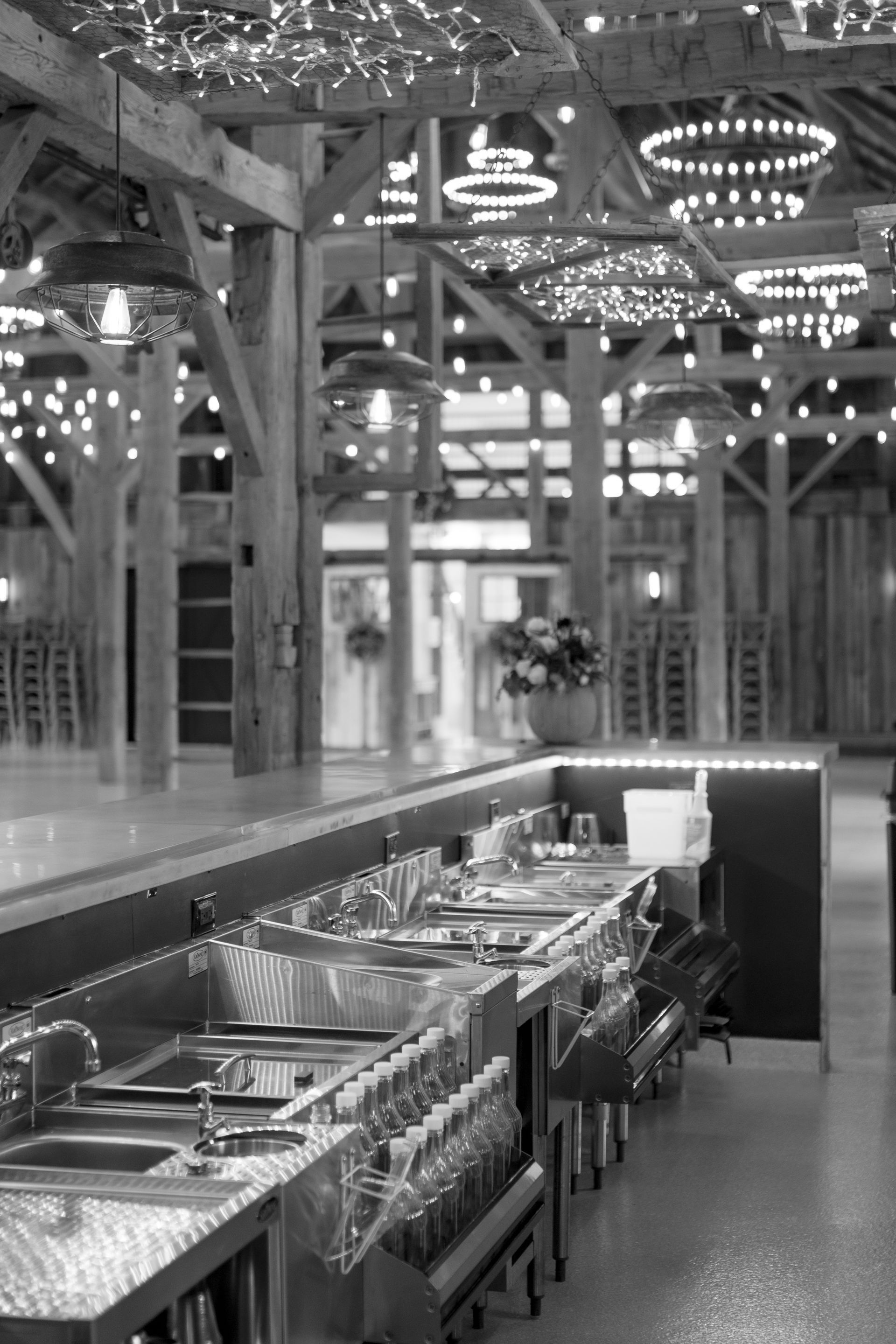 Indoor buffet line with stainless steel serving trays under an industrial-style ceiling.