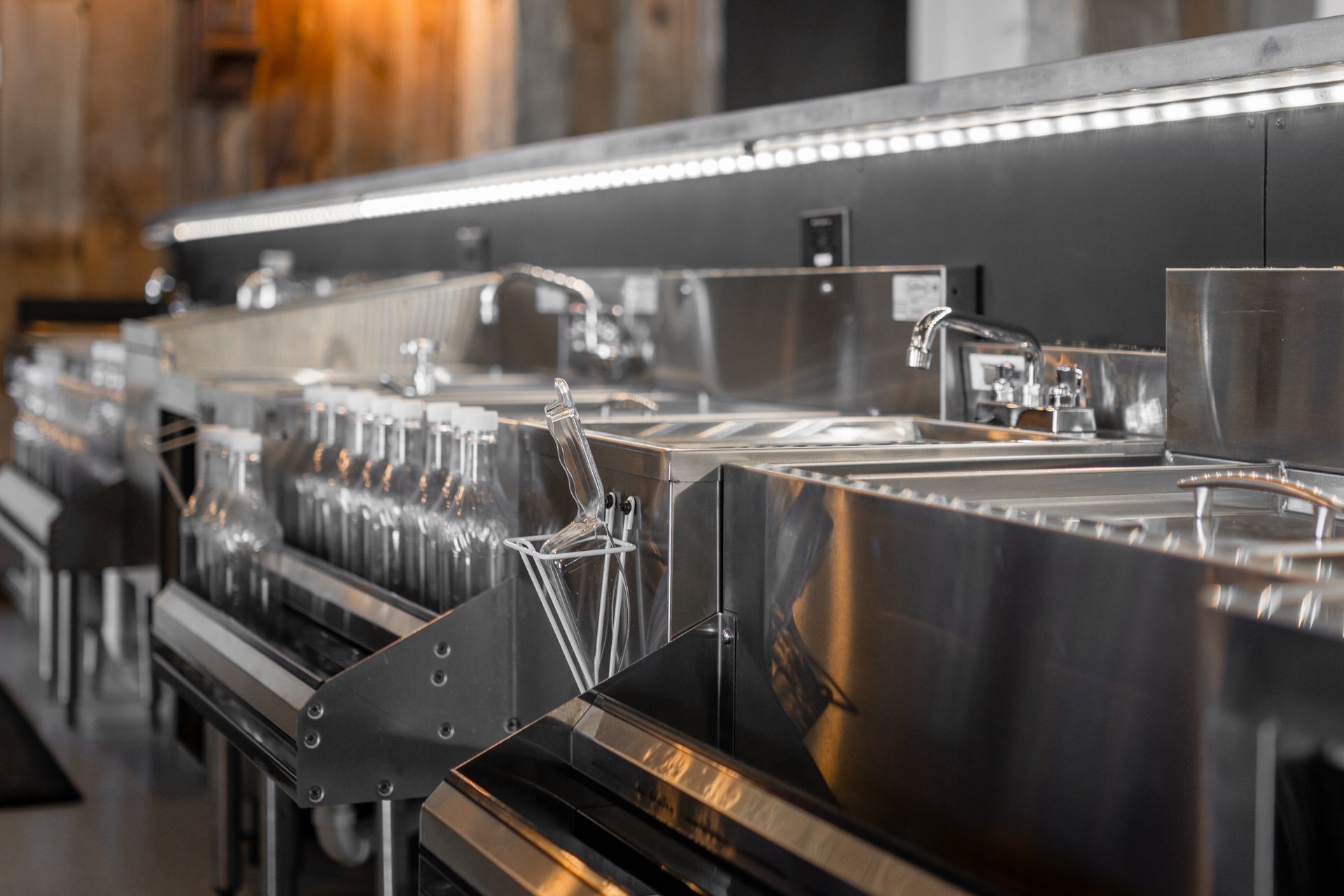 Stainless steel industrial machine with rows of metal containers in a modern facility