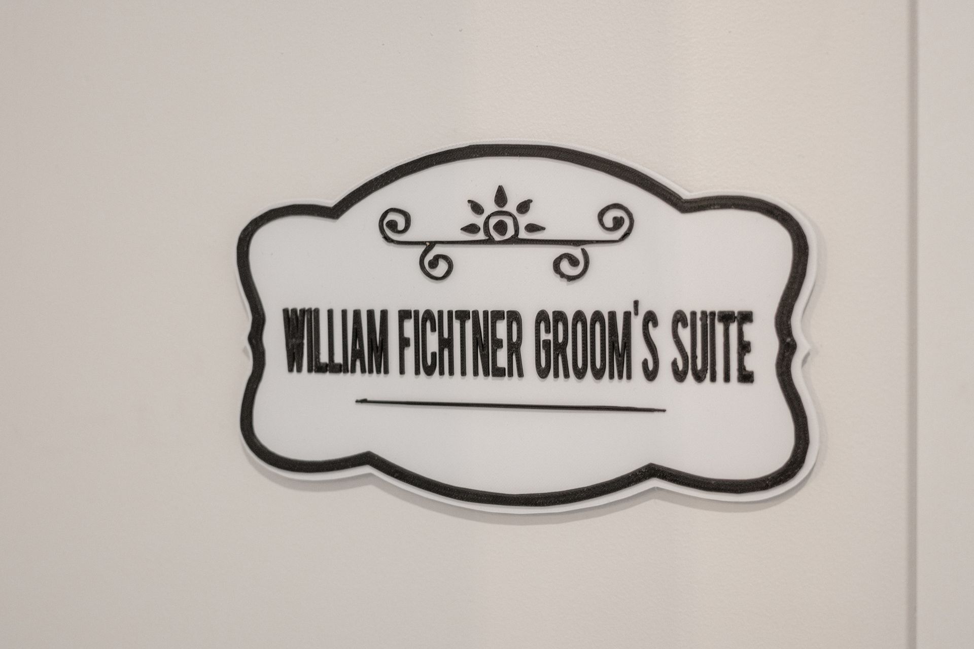 Decorative sign reading “William Fichter Room’s Suite” on a wall