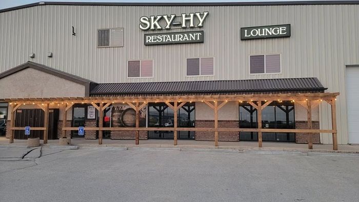 Front view of Sky-Hy Restaurant and Loxnix building with covered entrance and gravel parking lot