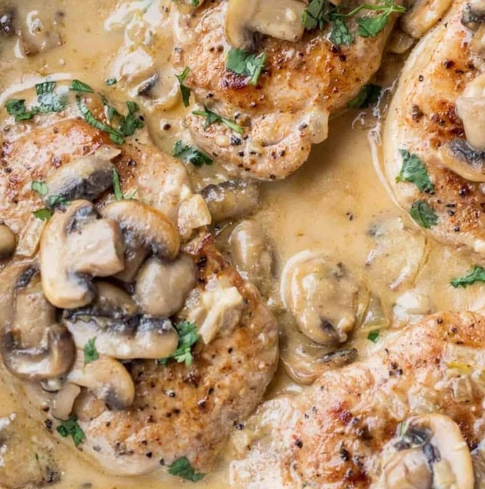 Chicken breasts in creamy mushroom sauce, garnished with parsley