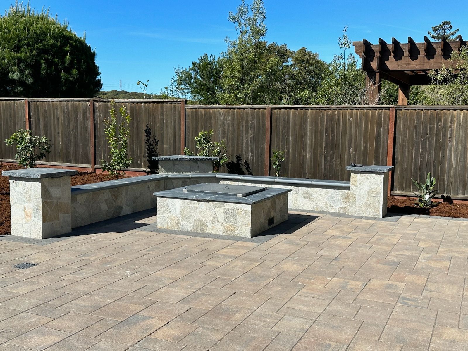 There is a fire pit in the middle of the patio.