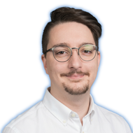 Portrait of a man with glasses, mustache and goatee in a white shirt against a white background