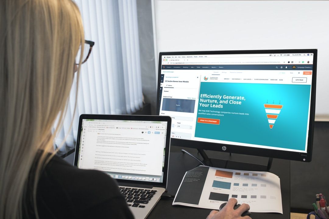 Person editing website design on monitor for making a website for a small business