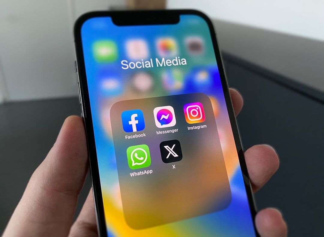 Hand holding phone displaying social media app icons for social media management packages