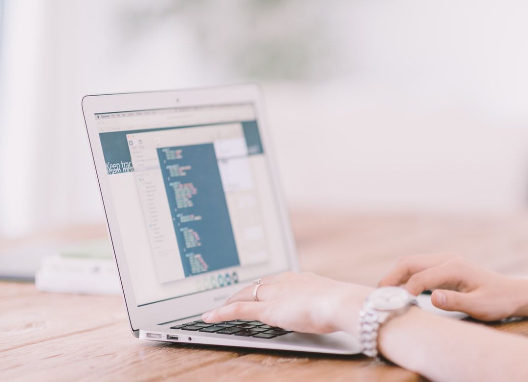 Hands typing on laptop with tracking software for what is marketing automation