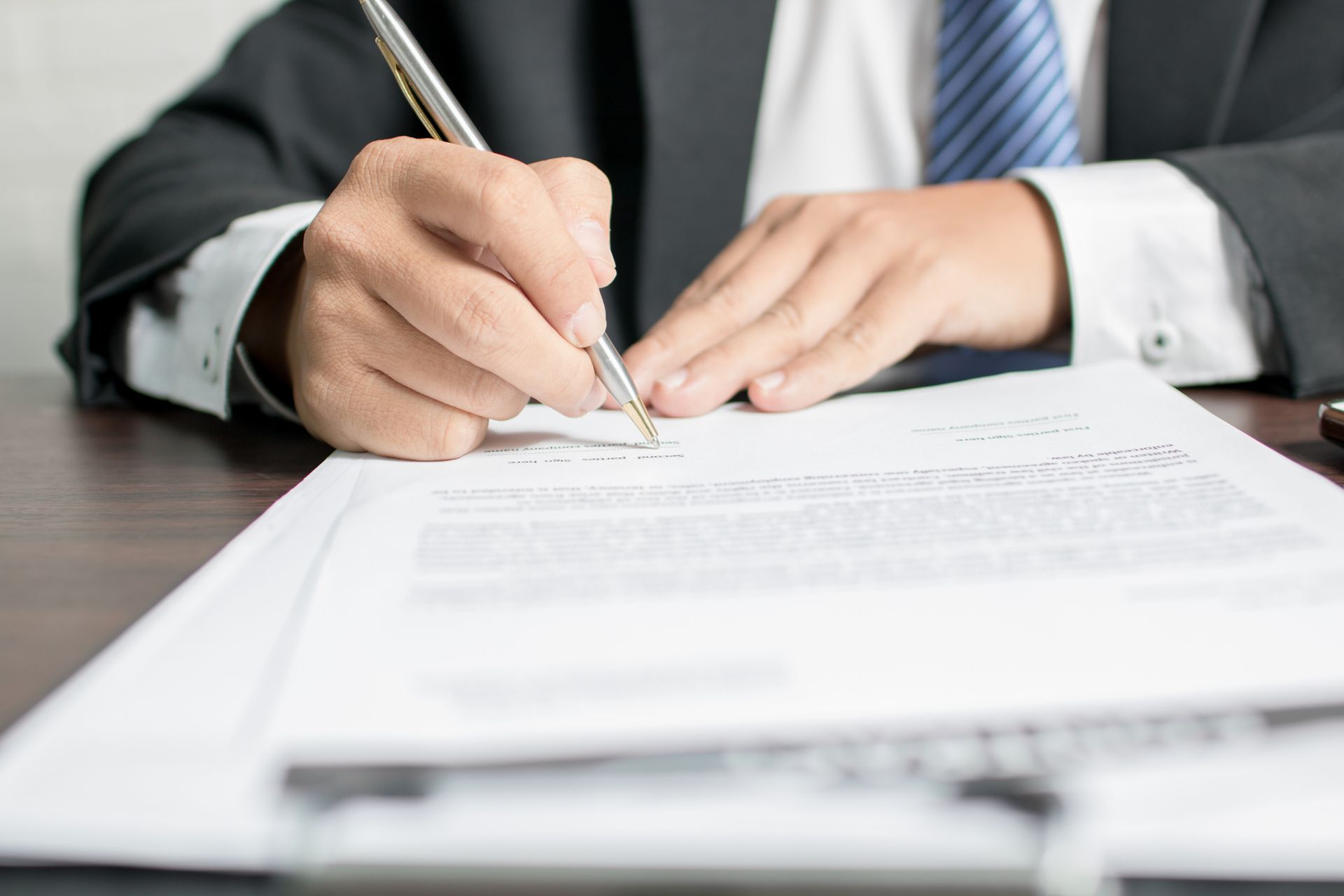 Office agent representing insurance agency expertise while signing important contract documents.