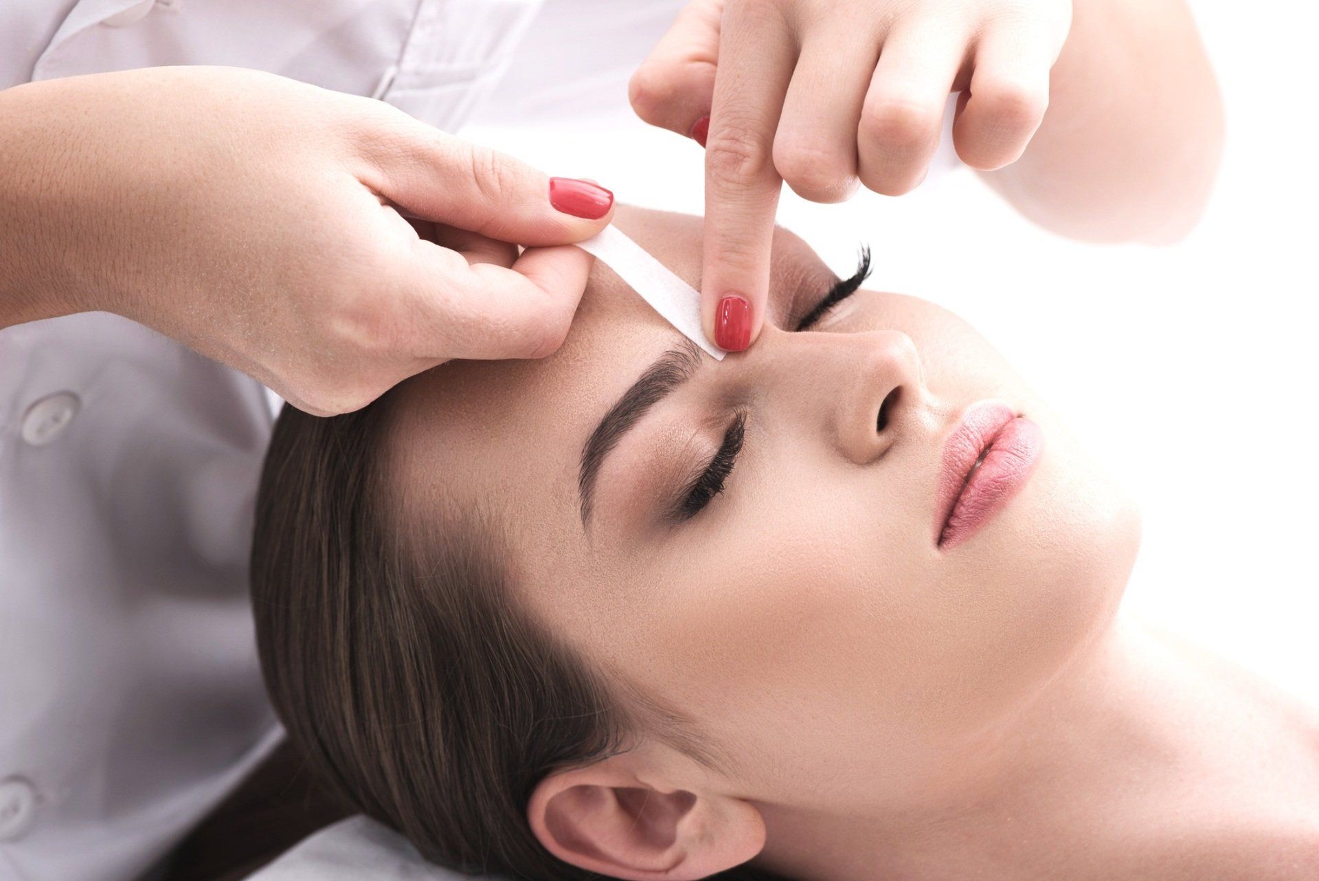 Facial massage with fingers pressing the forehead and bridge of the nose