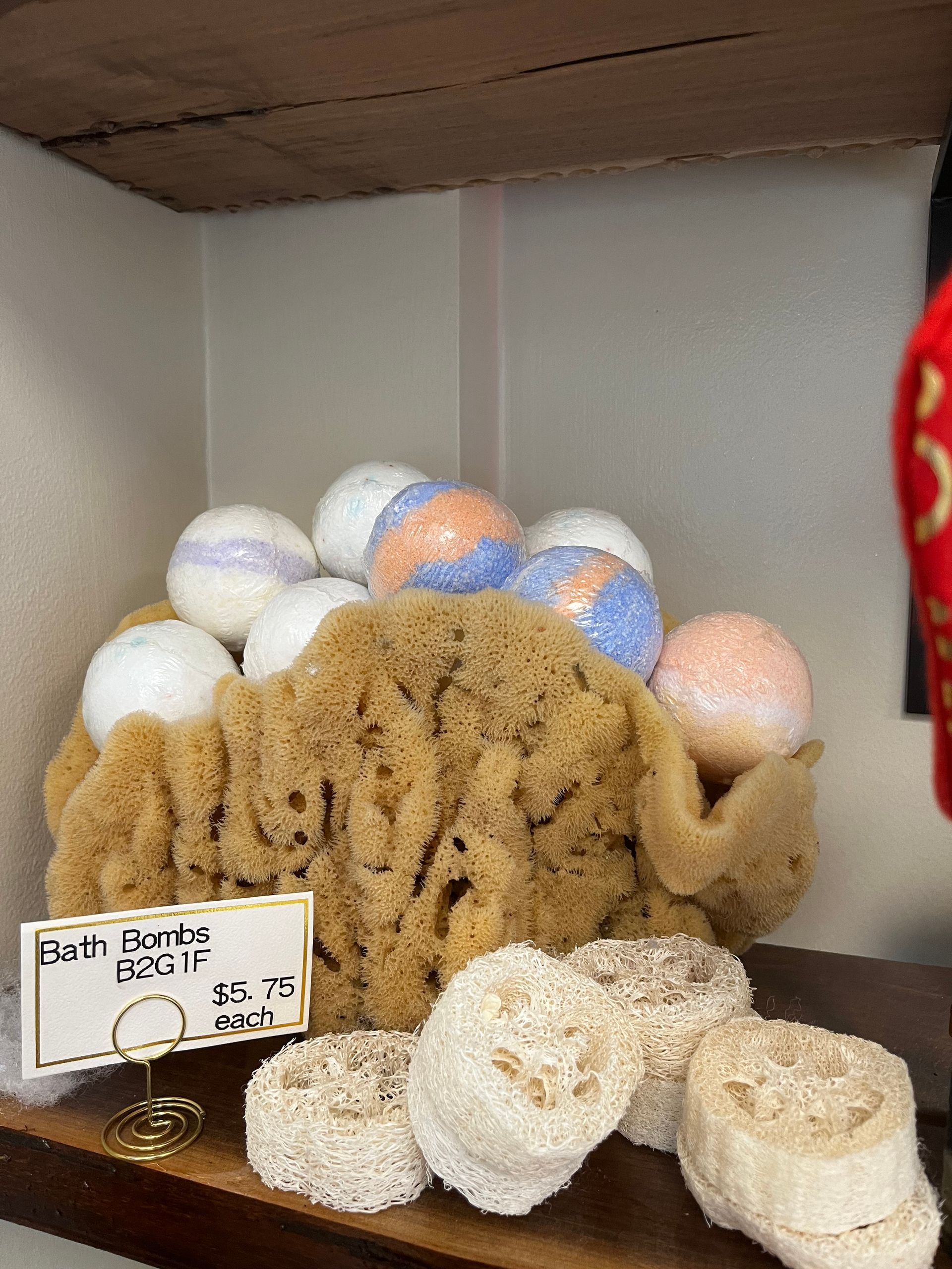 Box of assorted cookies with a small price sign inside a display case