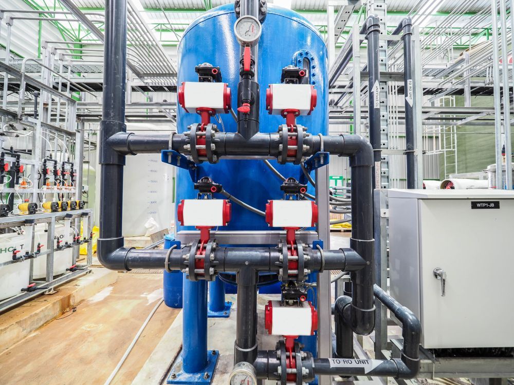 A Large Blue Tank With a Lot of Pipes and Valves in a Factory — Switchboard & Power Controls Pty Ltd in Alice Springs, NT