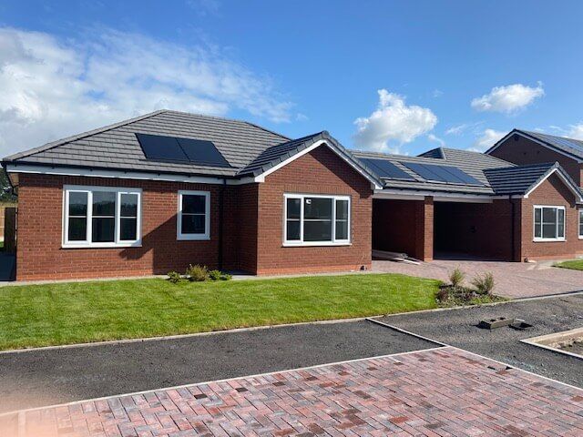 A brick house with solar panels on the roof