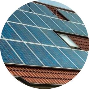 There are many solar panels on the roof of a house.