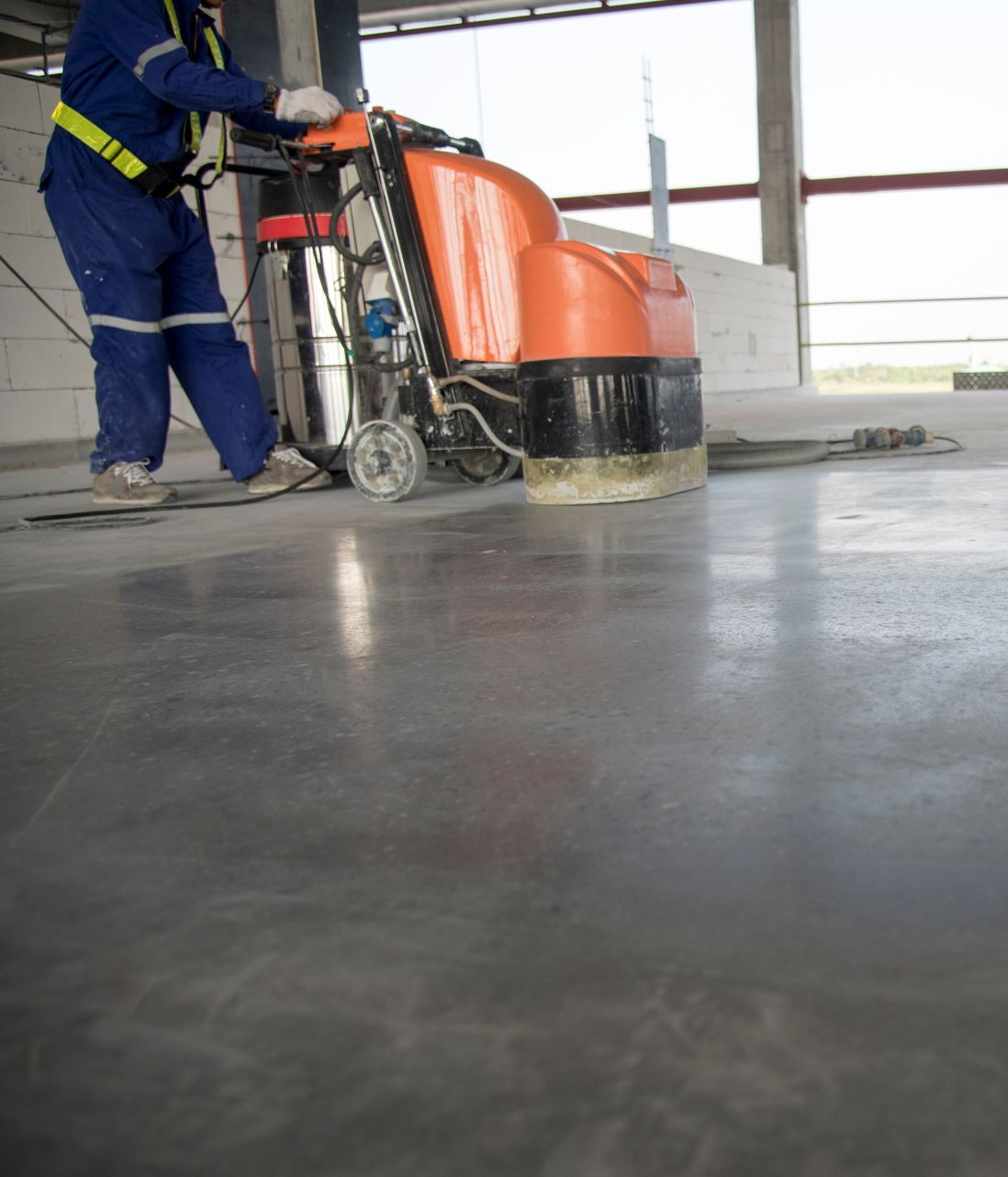 Two Workers Cleaning A Concrete Floor In A Construction Area — Rocky Commercial Cleaners In Berserker, QLD