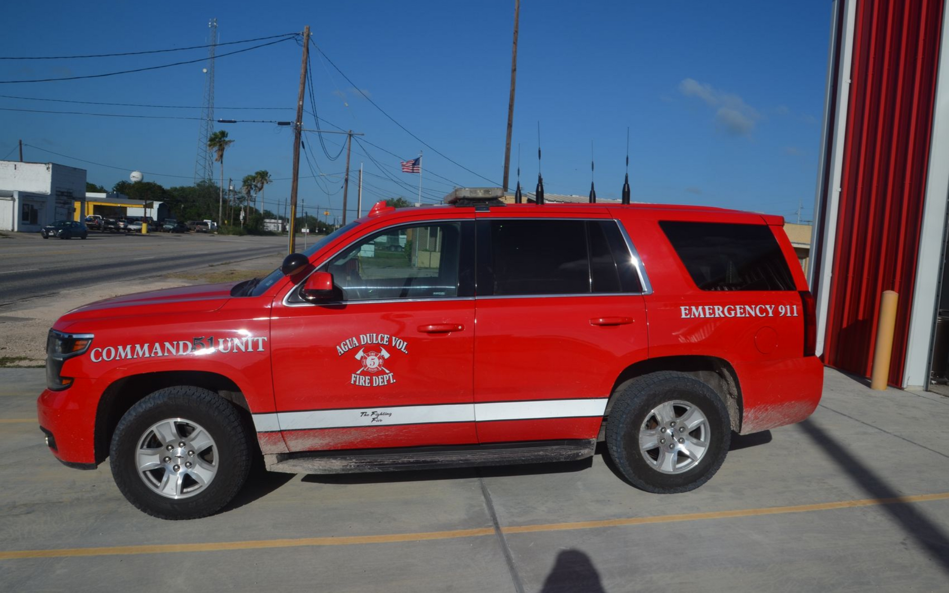 Red emergency SUV parked by a building, with “COMMAND” markings and red paint.