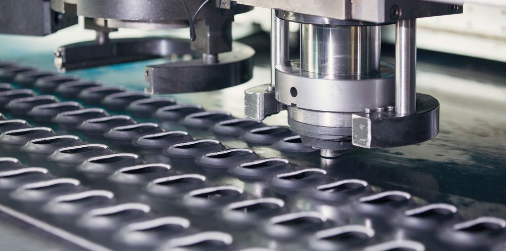 A Machine is Cutting a Piece of Metal in a Factory — Total Engraving In Sandgate, NSW