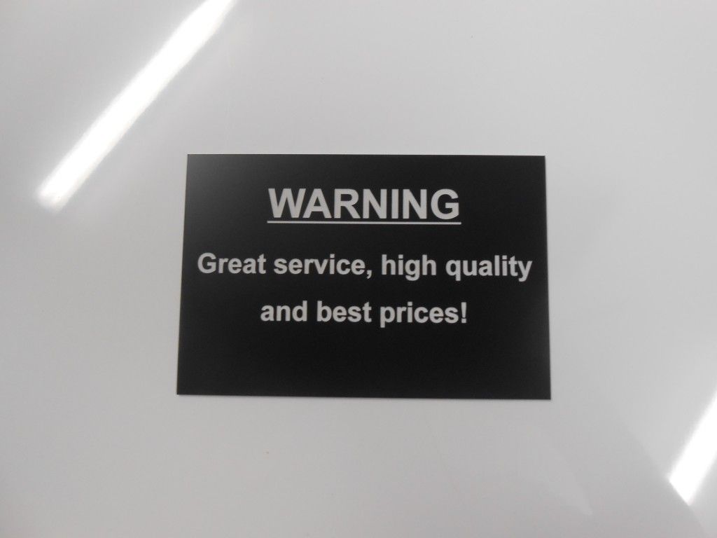 A Black Sign That Says Warning Great Service High Quality and Best Prices — Total Engraving In Sandgate, NSW
