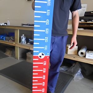 A Man is Holding a Blue and Red Ruler That Shows Inches and Centimeters — Total Engraving In Sandgate, NSW