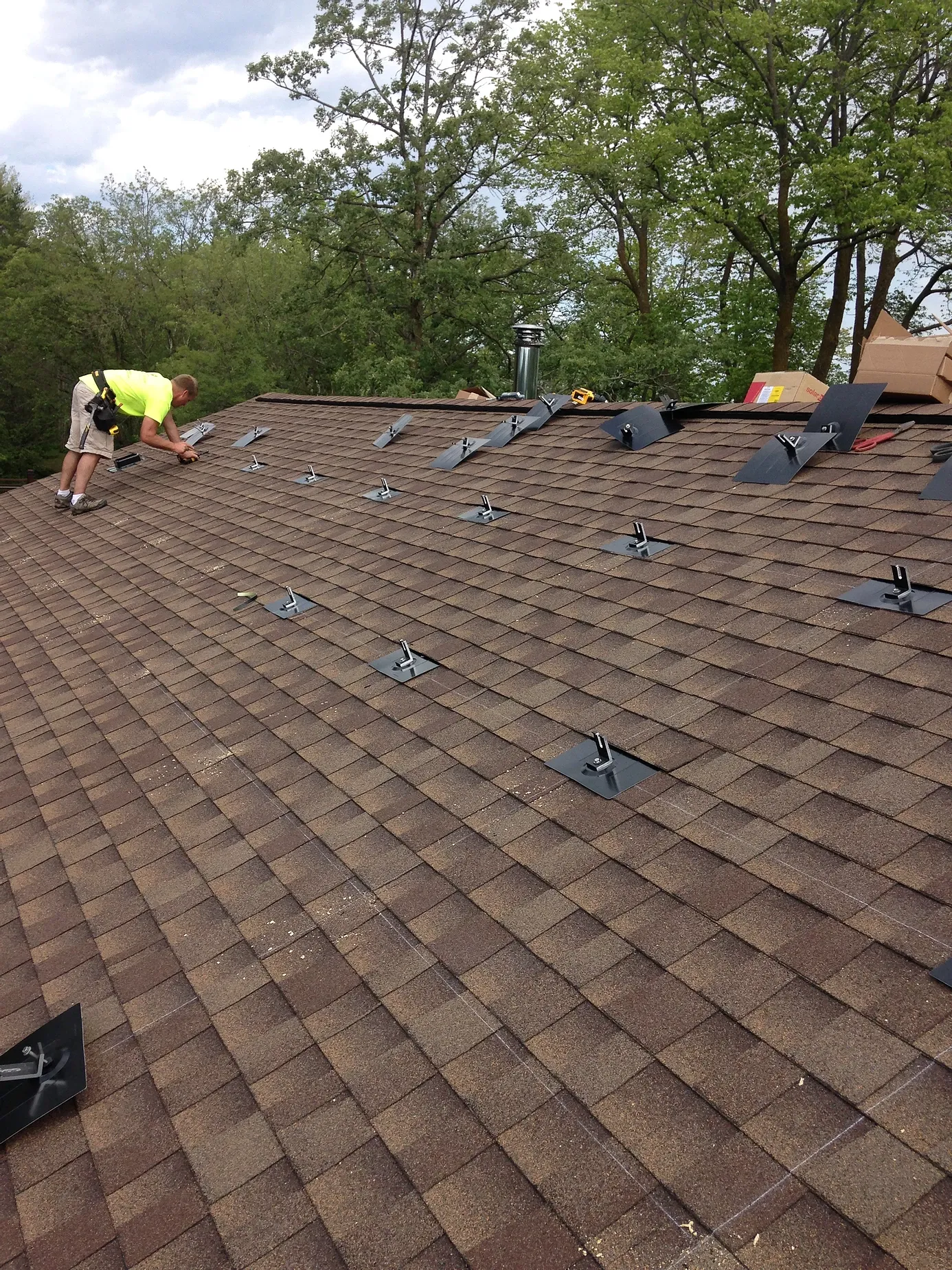 A man is working on the roof of a house.