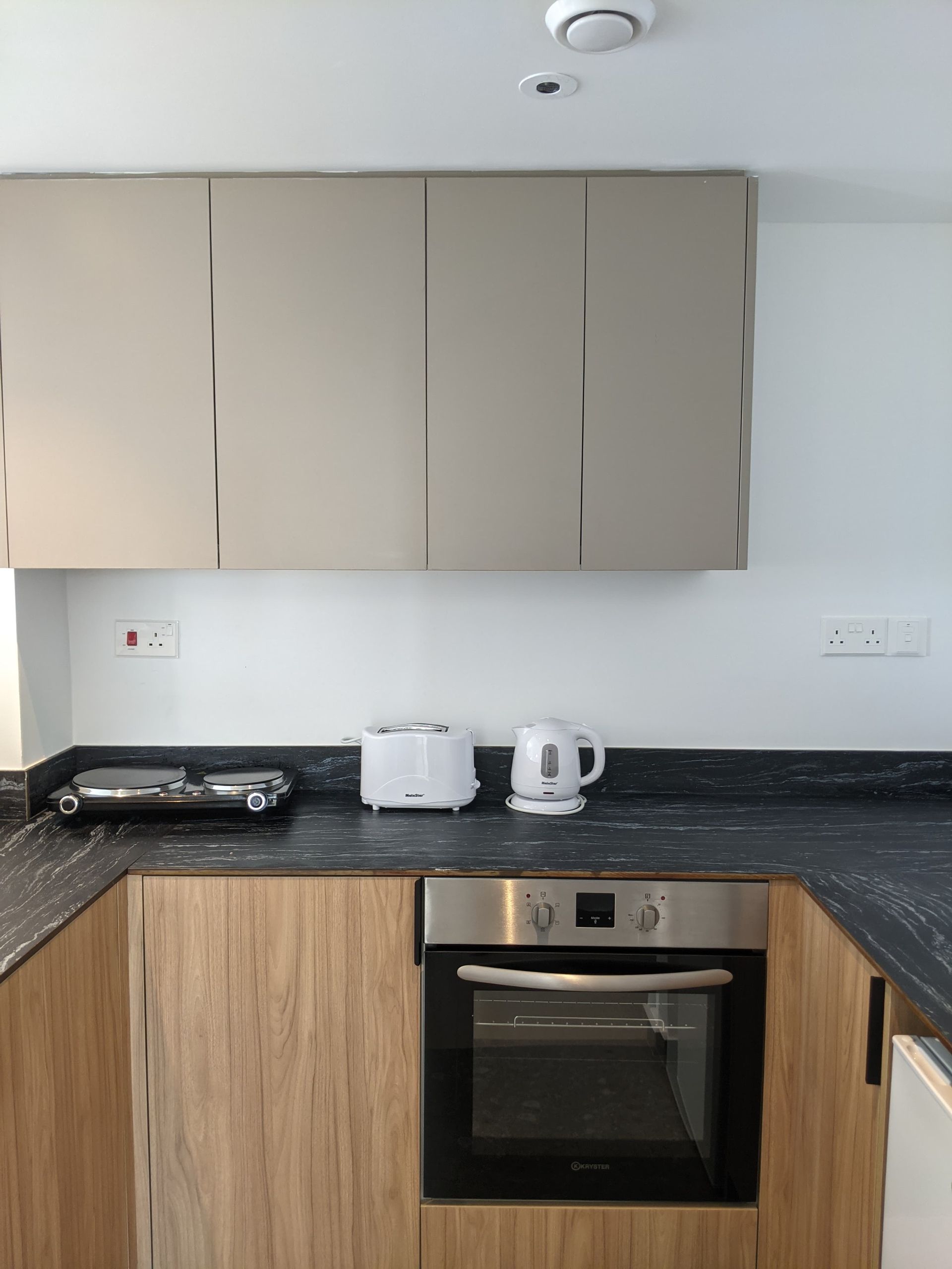 A kitchen with stainless steel appliances and wooden cabinets.