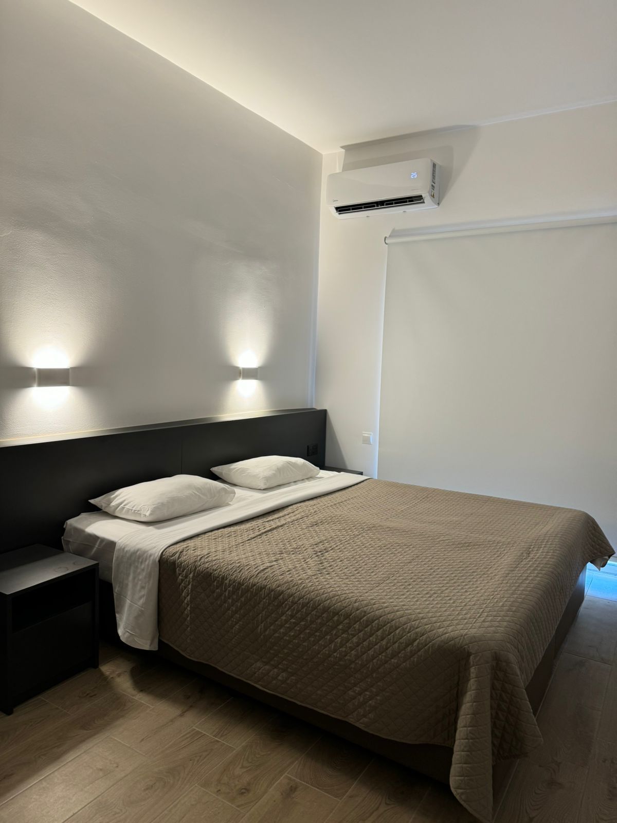 A bedroom with a large bed and a window