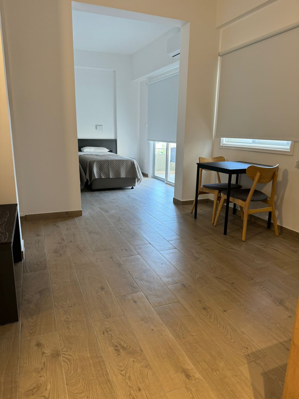 There is a table and chairs in the middle of the room.