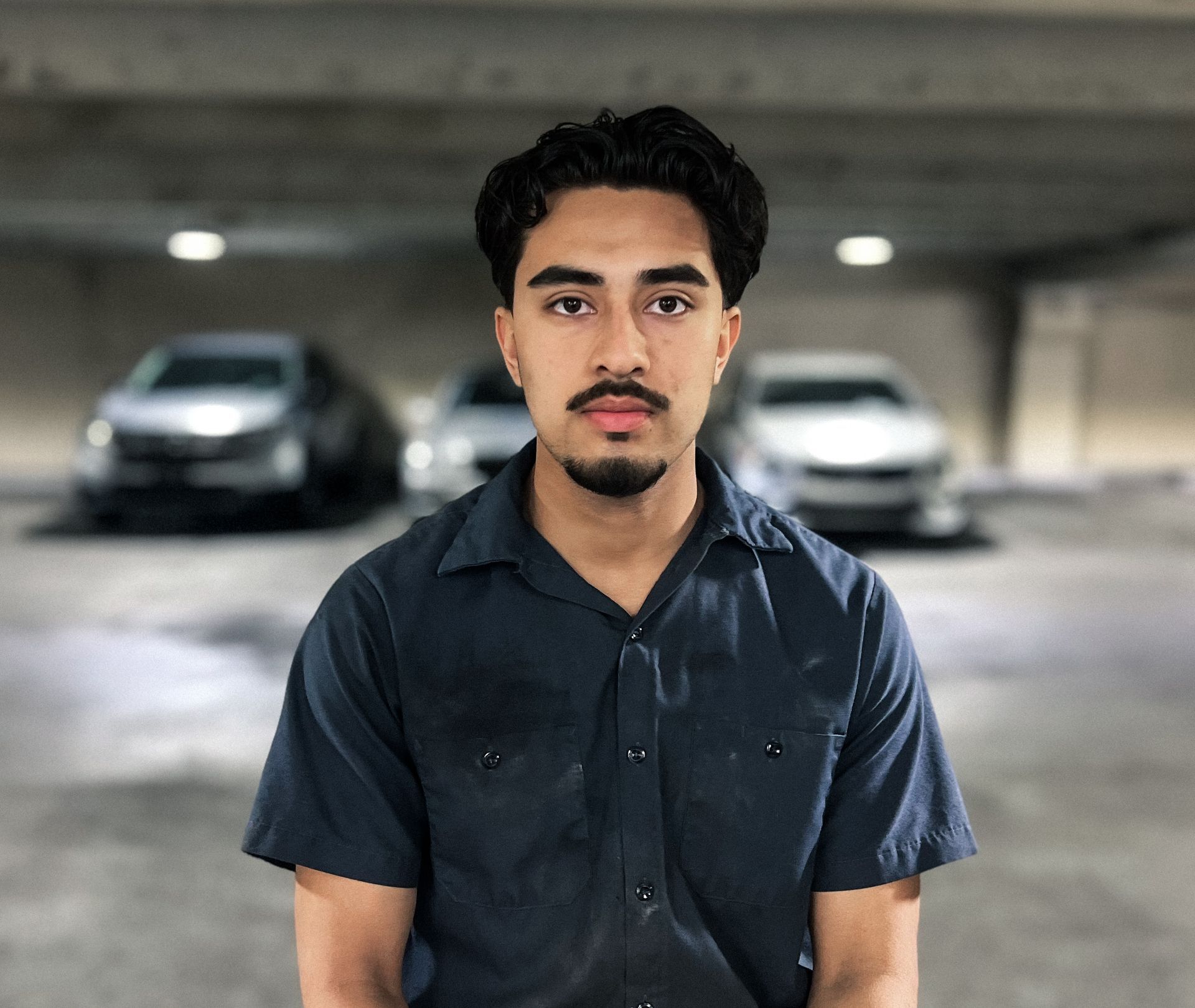 Young man holding up a bright red 