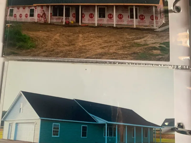 Two house photos on a page: a white house with red trim above and a blue house below.