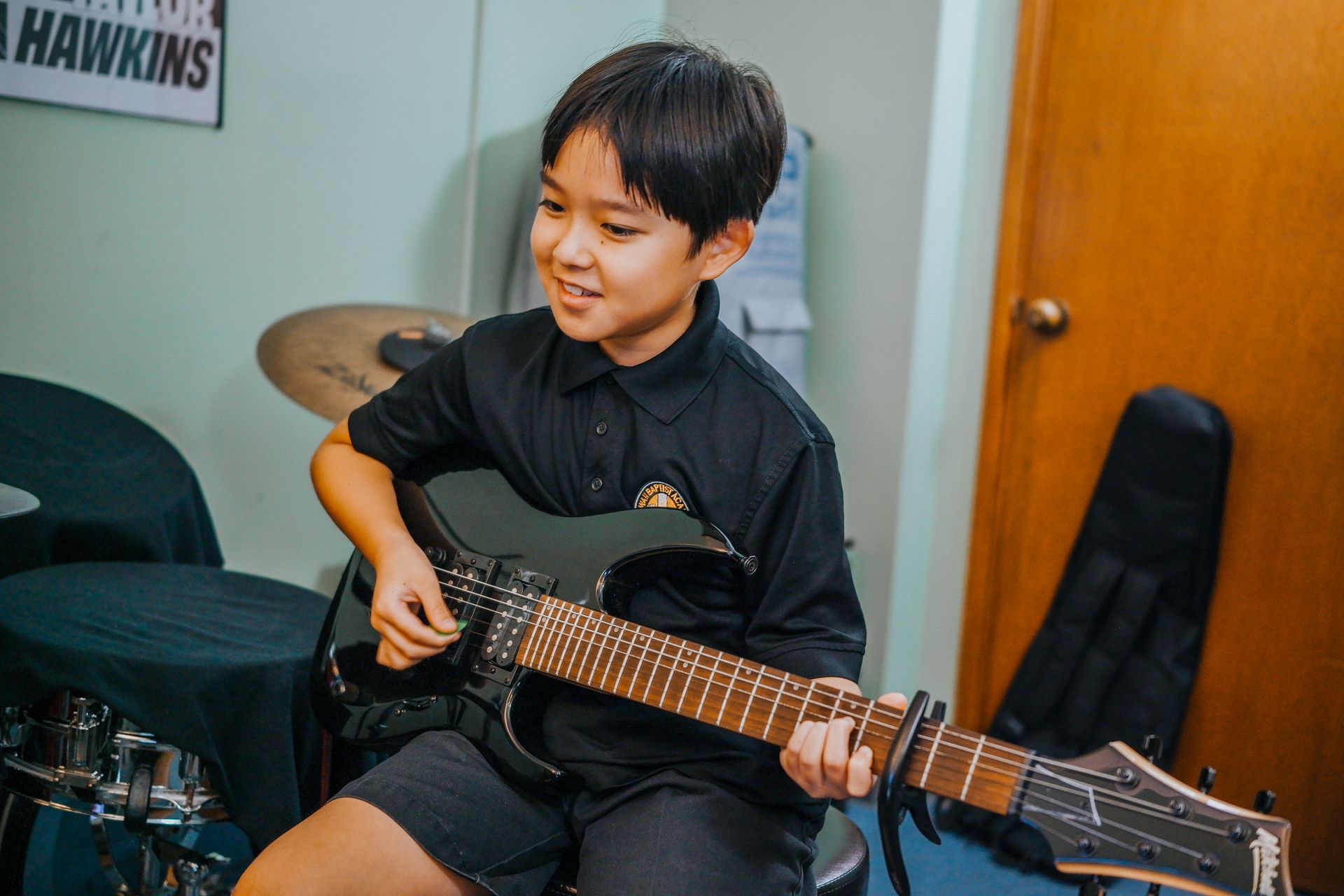 Young Boy Playing Guitar — Pearl City, HI — Hawaii Musicworks Young Boy Playing Guitar — Pearl City, HI — Hawaii Musicworks — Aiea — Kapolei — Ewa Beach — Honolulu — Wahiawa — Waipahu — Mililani