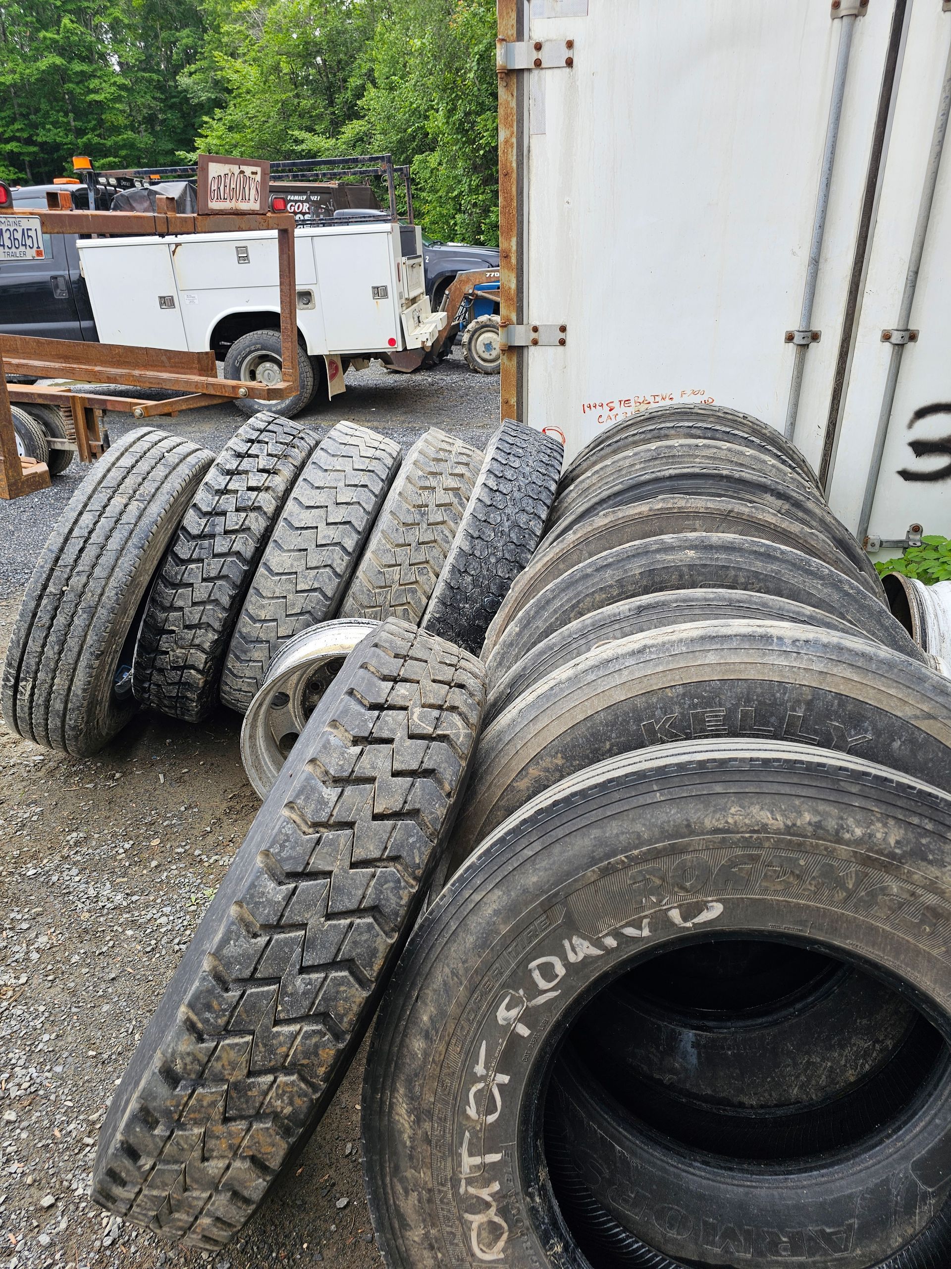 A bunch of tires are stacked on top of each other in a pile.