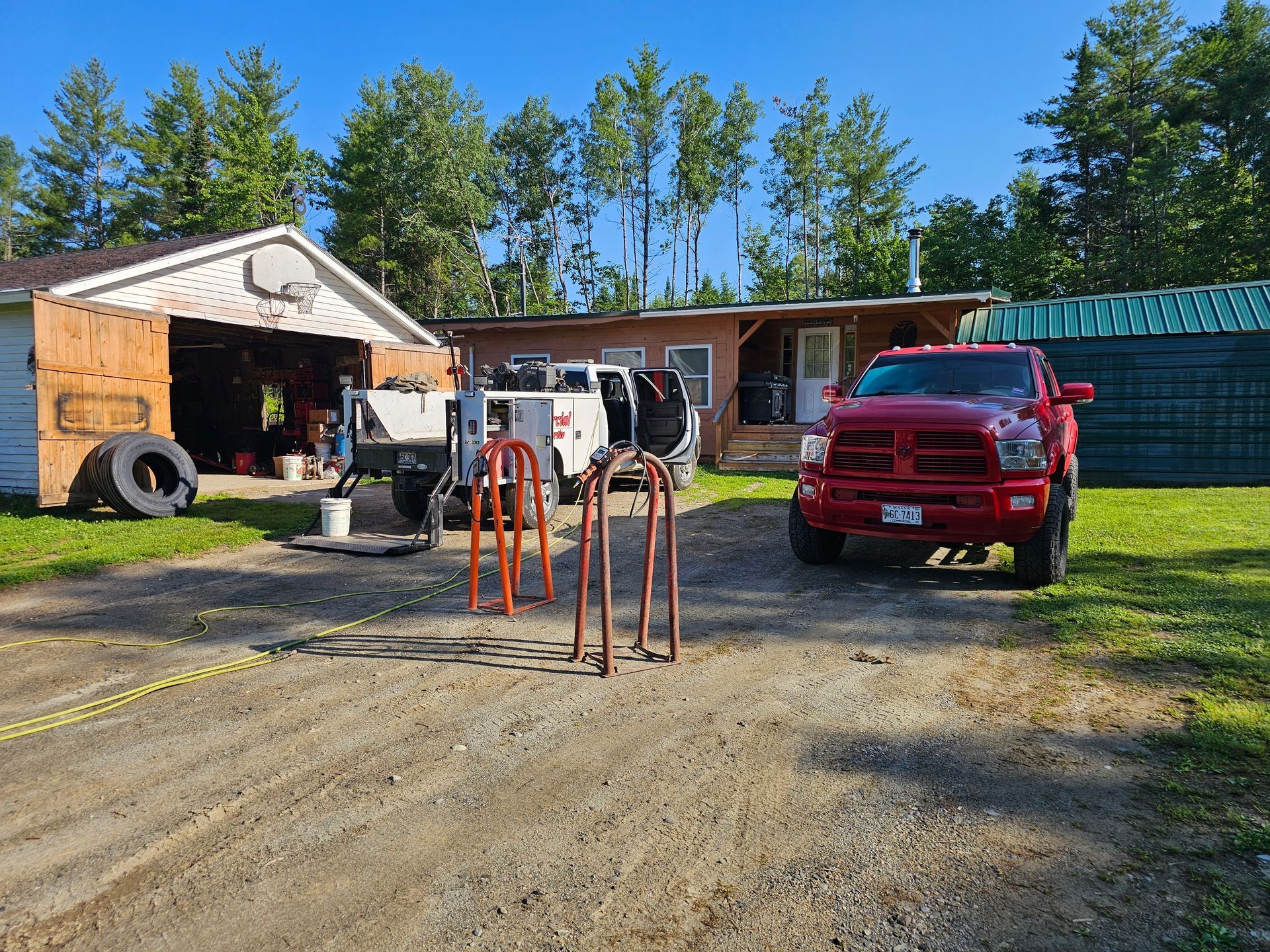 A red truck is parked in front of a house.