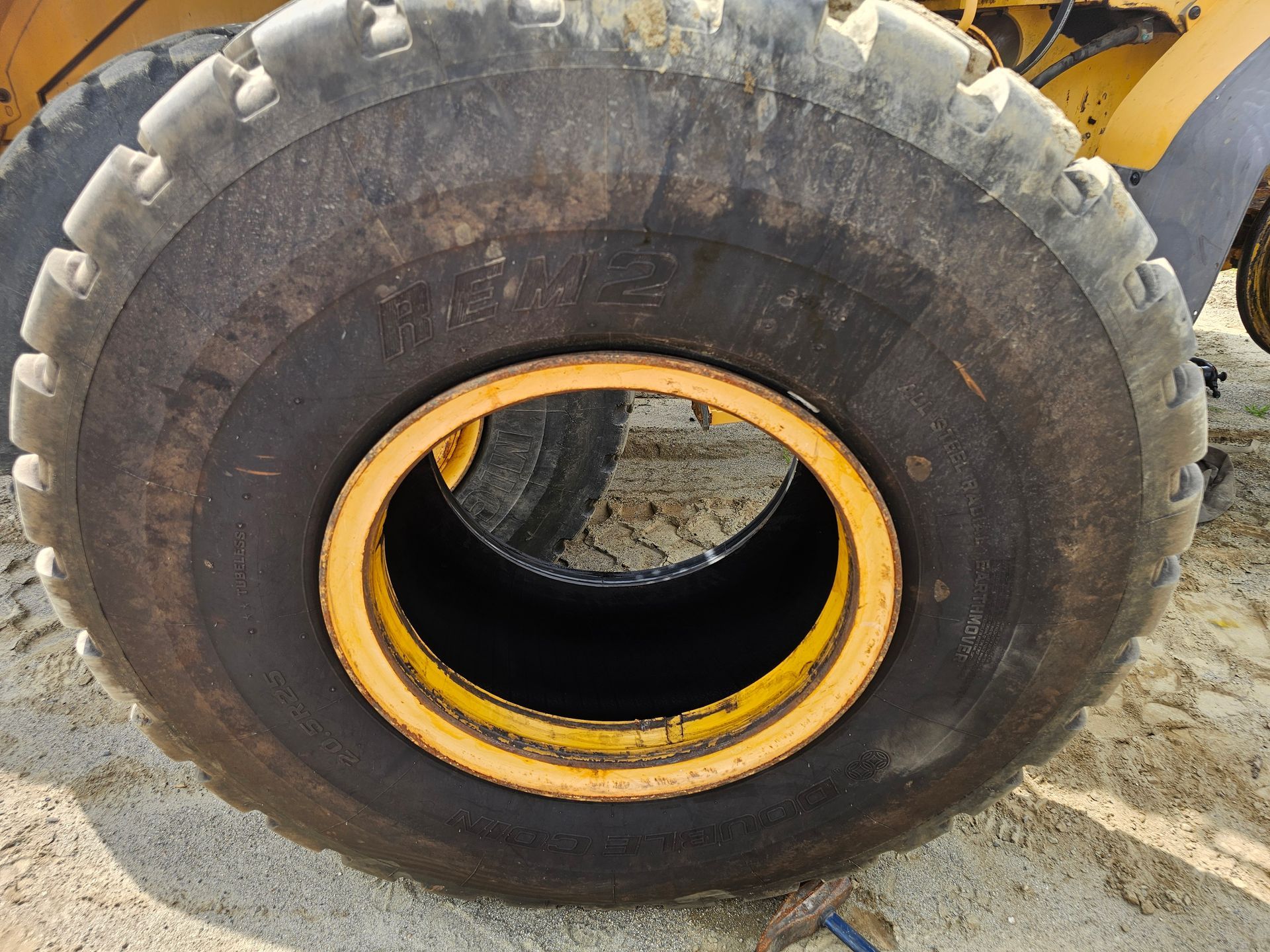 A close up of a tire with a yellow rim
