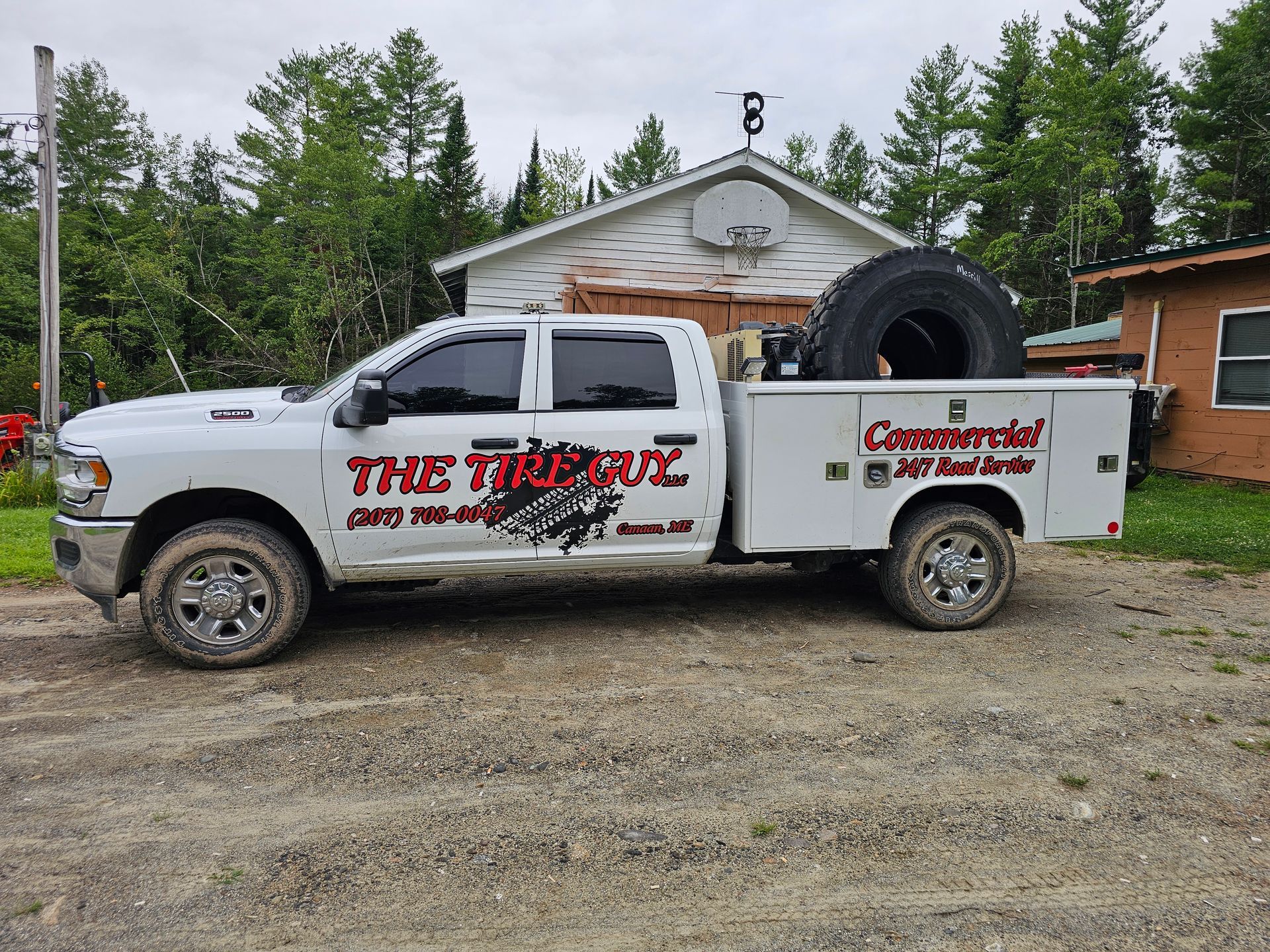 A white truck is parked in front of a house.