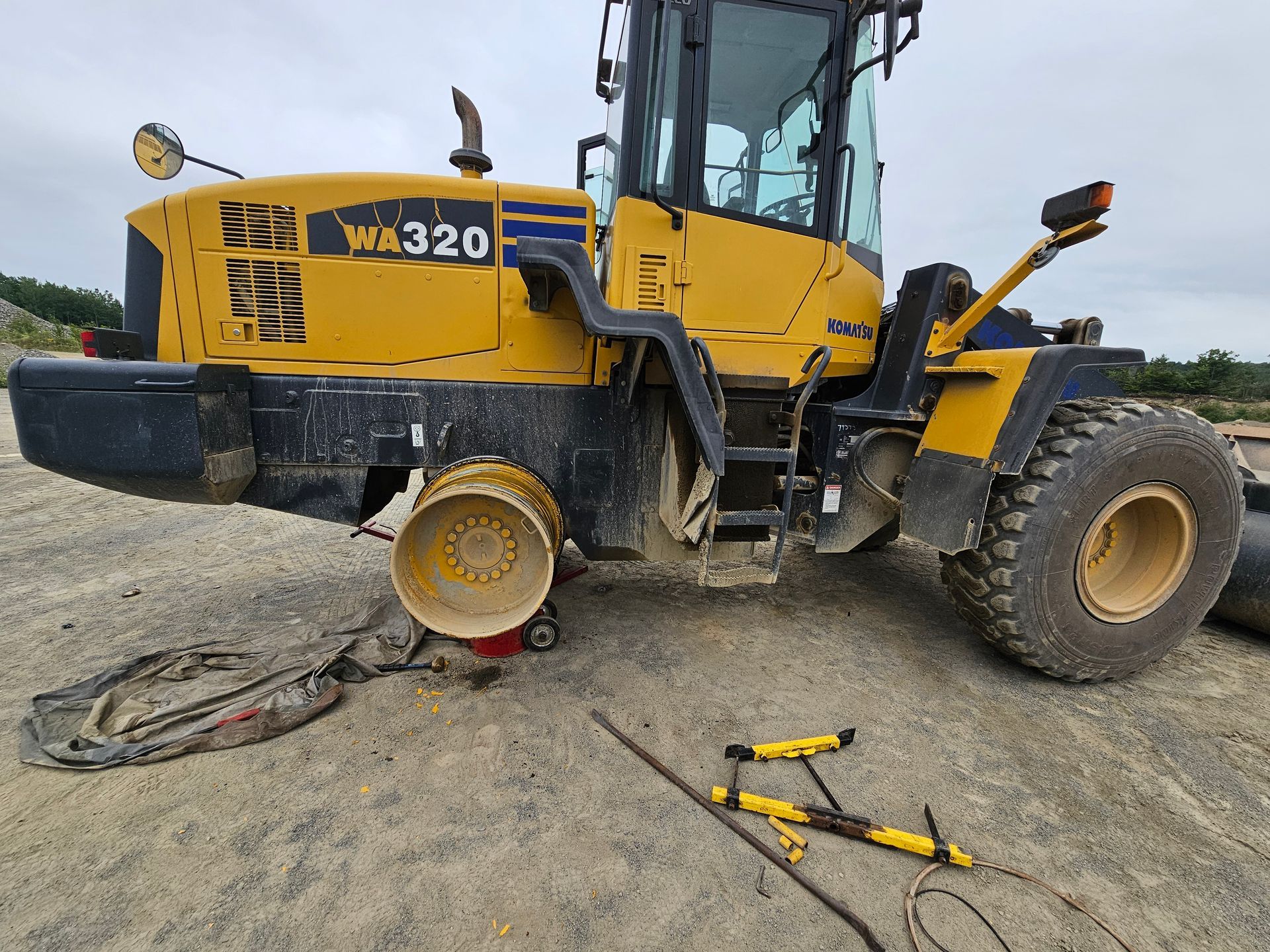 A yellow and black tractor with the word wa320 on it