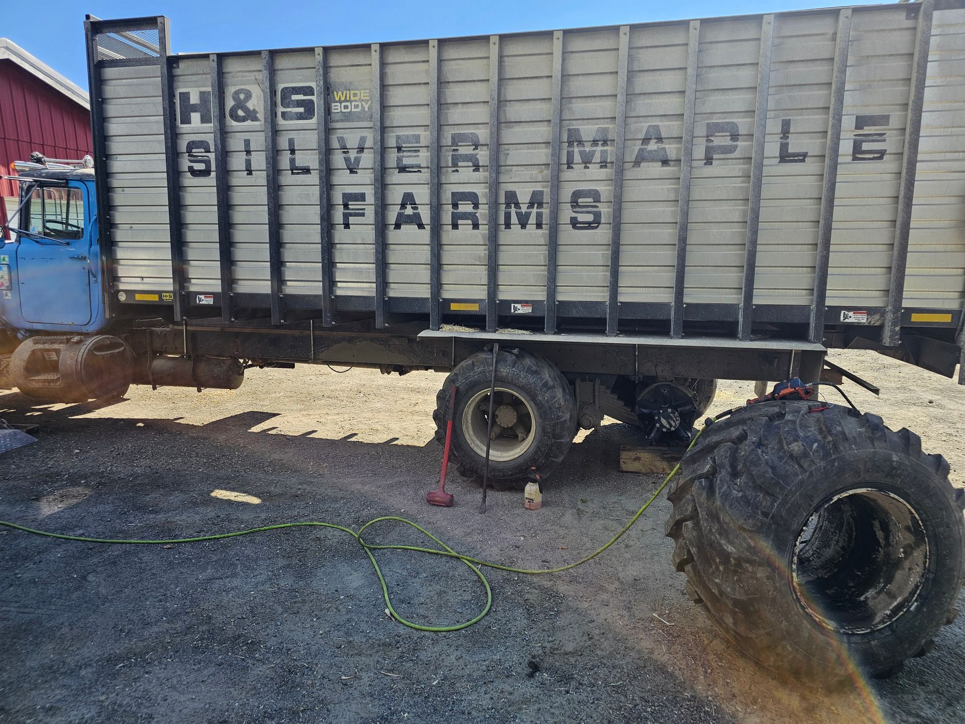 A silver maple farms truck is parked on the side of the road