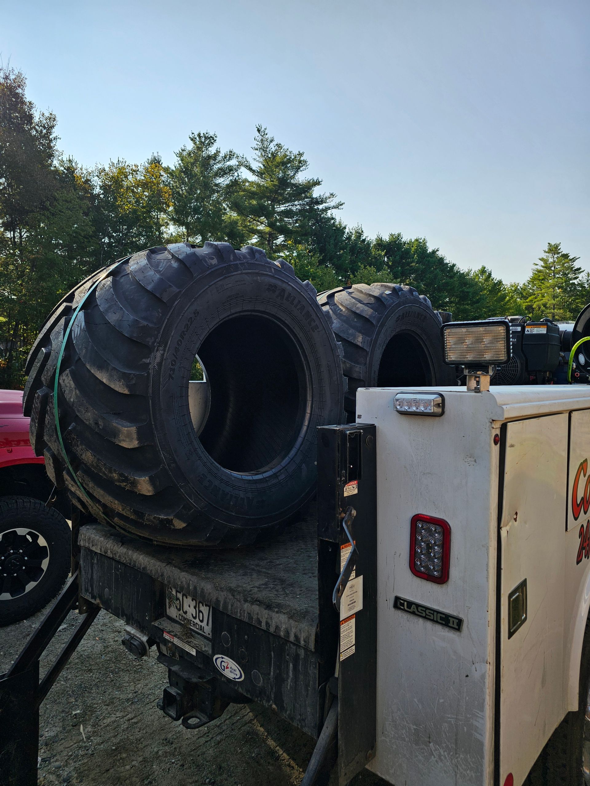 Two tires are sitting on the back of a truck.