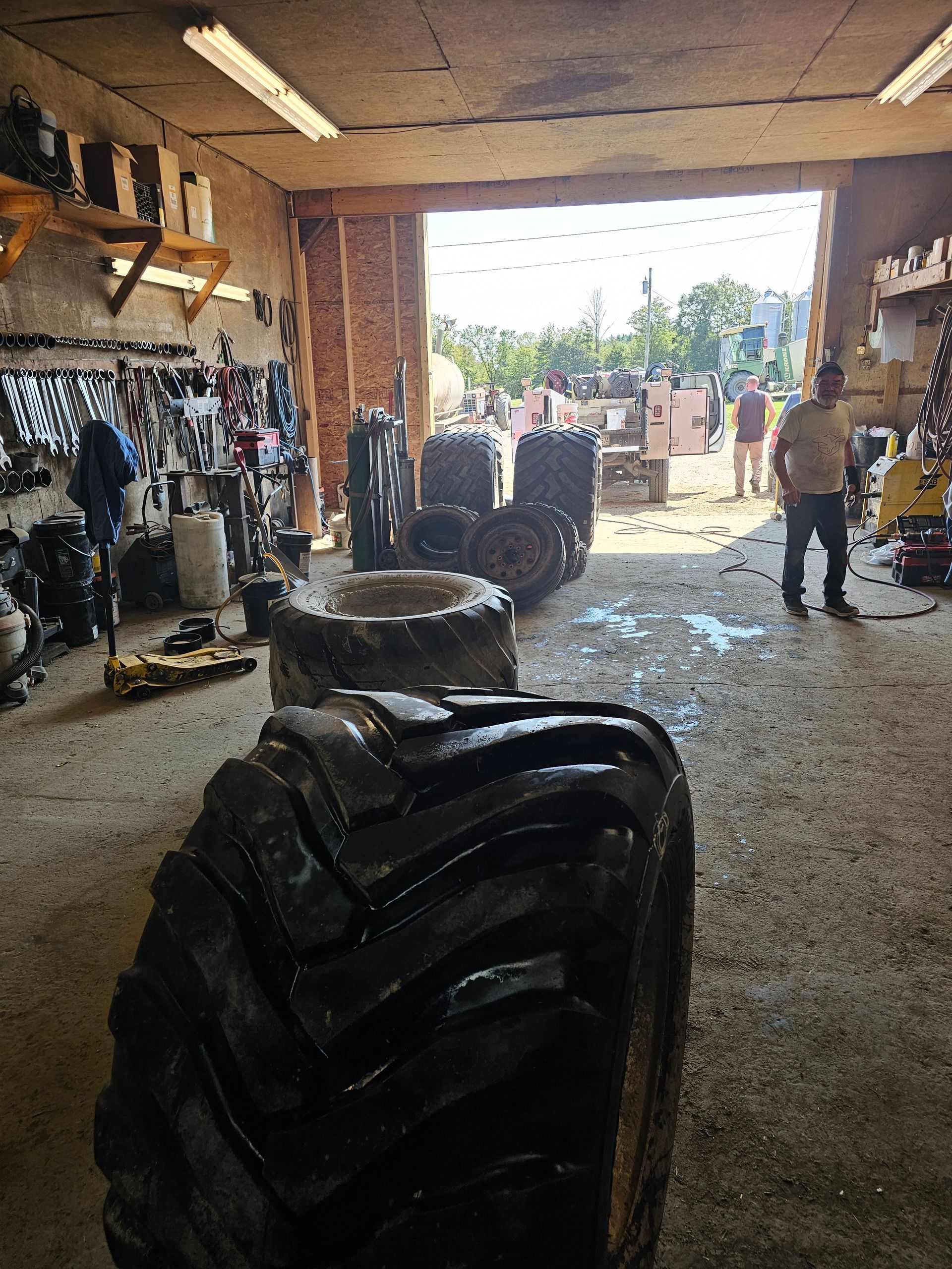 A large tire is in the middle of a garage.