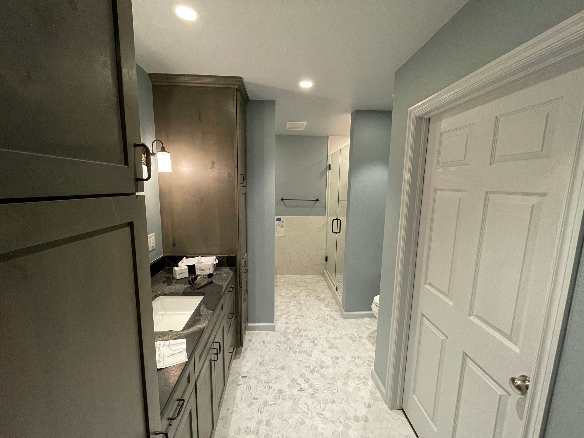 Tulsa Bathroom remodel spa shower stained glass mosaic tile inset marble floor gothic black granite counter