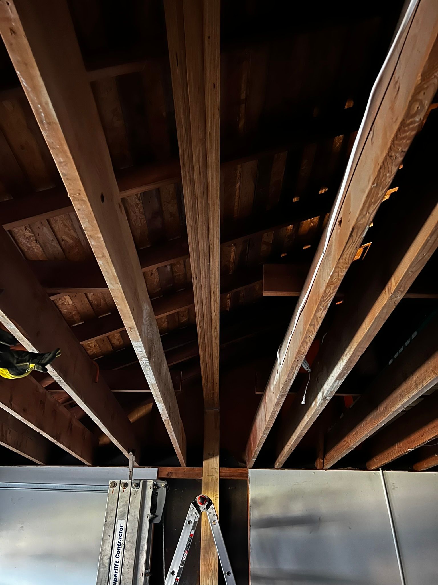 A ladder is hanging from the ceiling of a building.