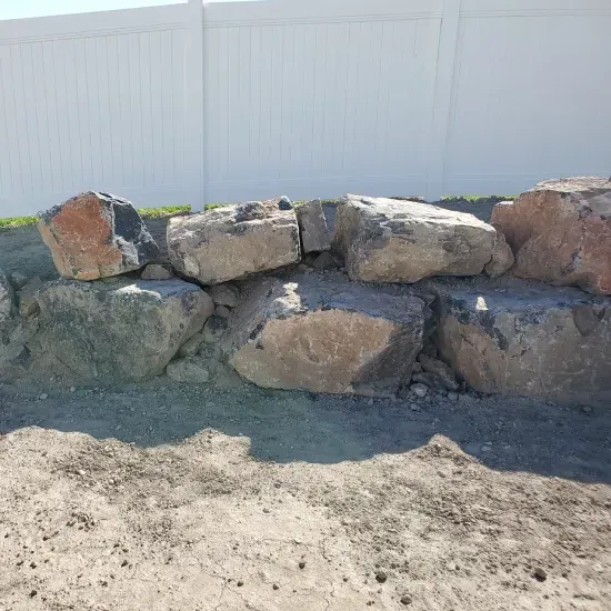 Residential boulder landscaping in Ogden UT incorporating large decorative stones into outdoor living spaces