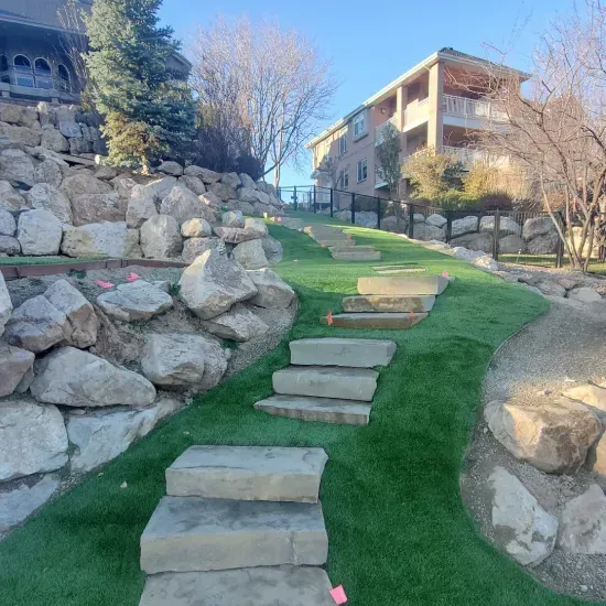Decorative yard boulder installation in Ogden UT enhancing residential landscapes with durable stone accents