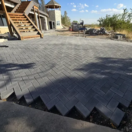 Stone patio landscape installation in Ogden UT adding elegance and value to outdoor environments
