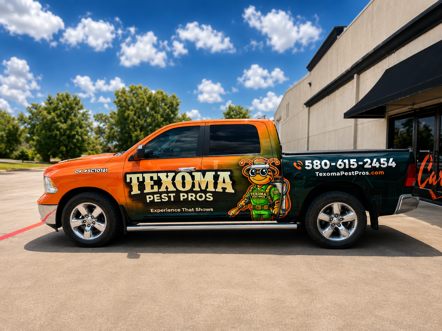 Texas Pest Pros orange-and-black pickup truck parked outside a building under a blue sky