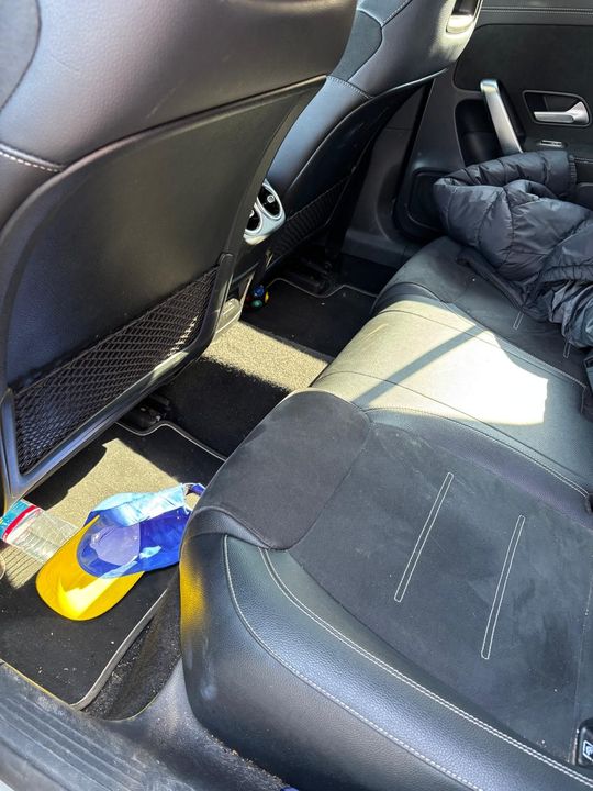 The interior of a range rover sport with white leather seats and a steering wheel has been detailed.