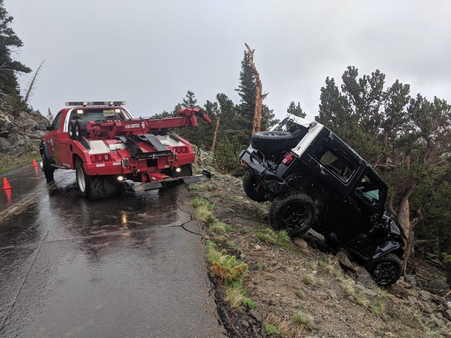 Illegally parked car being winched up on to flat deck tow truck