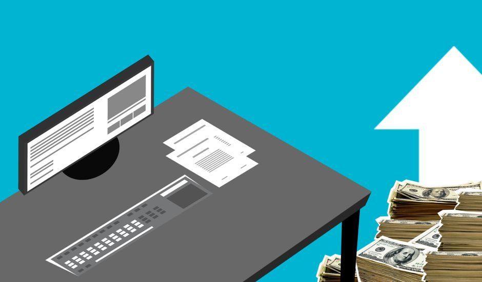 Desk with computer monitor, papers, and stacked cash beside a large upward arrow on a blue background